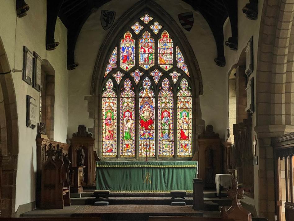 A stained glass window in a church

Description automatically generated