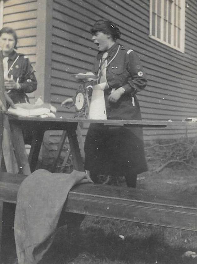 A group of women standing in front of a bench

Description automatically generated