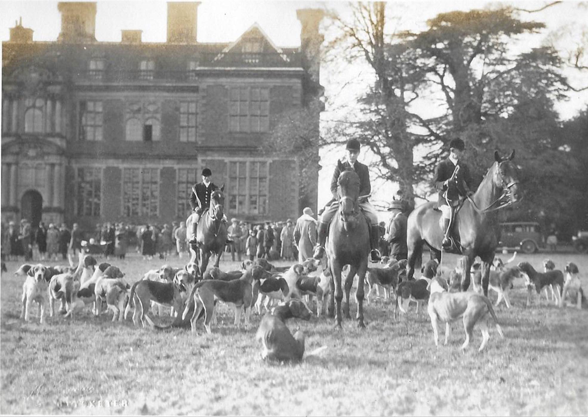 A black and white photo of people in a field

Description automatically generated