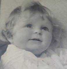 A black and white photo of a baby

Description automatically generated