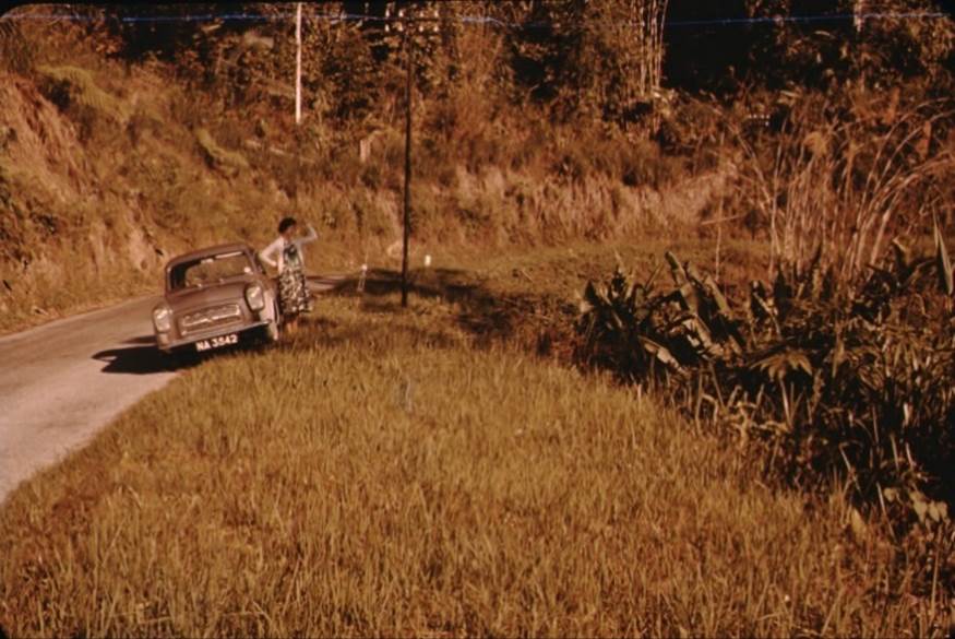 A person standing next to a car

Description automatically generated with low confidence