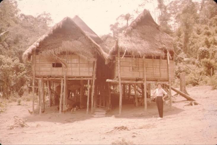 A person standing next to a house

Description automatically generated with low confidence