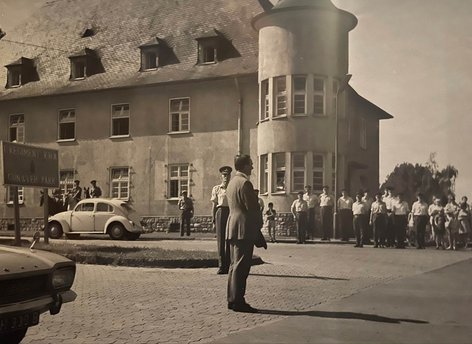 A group of people standing outside a building

Description automatically generated with low confidence