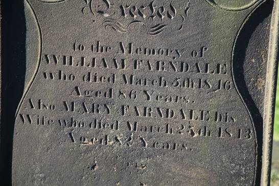 Close-up of a grave stone

Description automatically generated