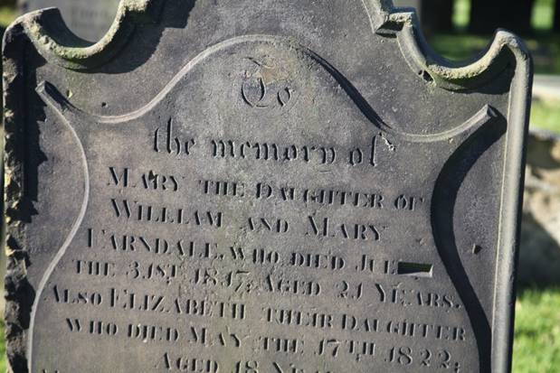 Close-up of a tombstone with engraved text

Description automatically generated