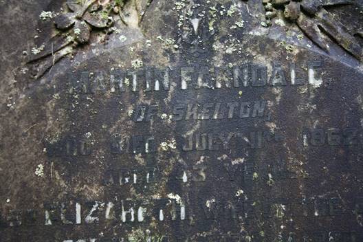 Close-up of a tombstone with engraved text

Description automatically generated