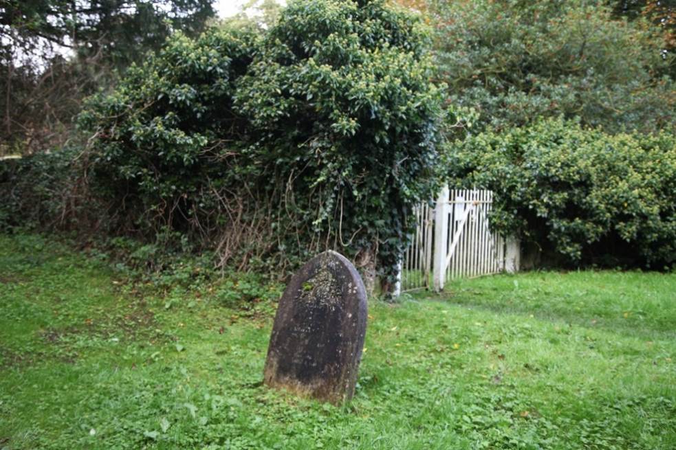 A tombstone in a cemetery

Description automatically generated