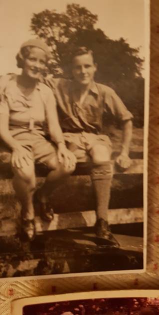 A couple of men sitting on a bench

Description automatically generated