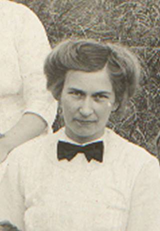 A vintage photo of a group of people posing for the camera

Description automatically generated