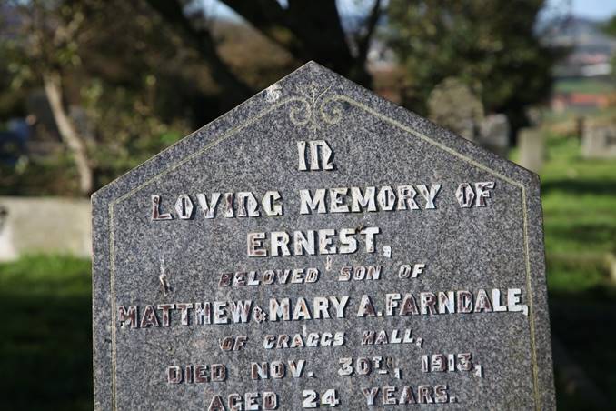 A close-up of a grave stone

Description automatically generated