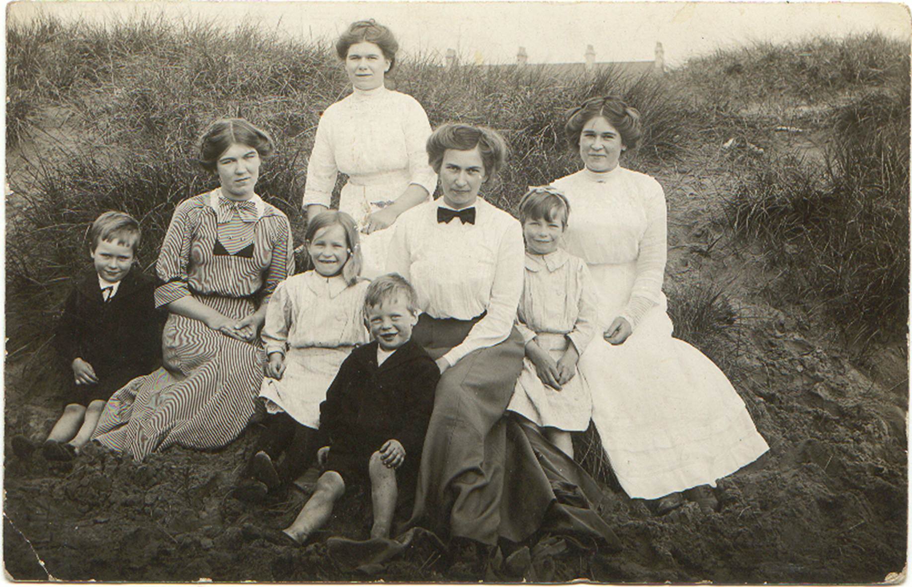 A vintage photo of a group of people posing for the camera

Description automatically generated