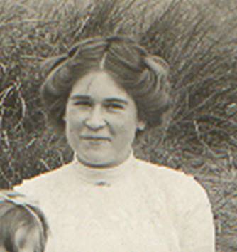 A vintage photo of a group of people posing for the camera

Description automatically generated