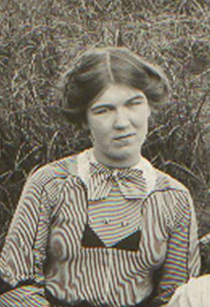 A vintage photo of a group of people posing for the camera

Description automatically generated