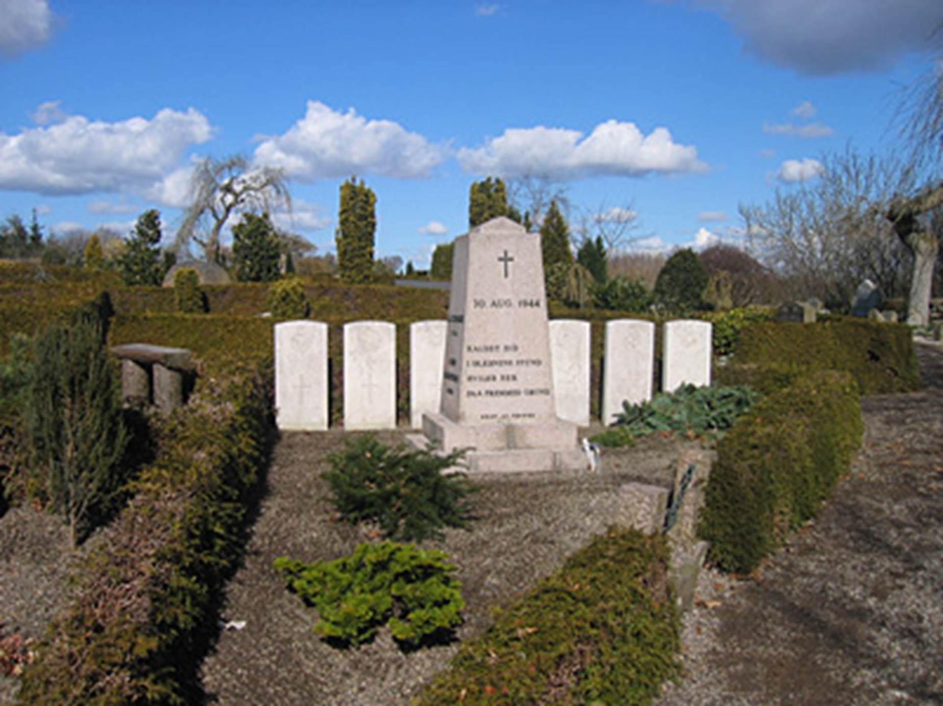 A grave stone in a cemetery

Description automatically generated