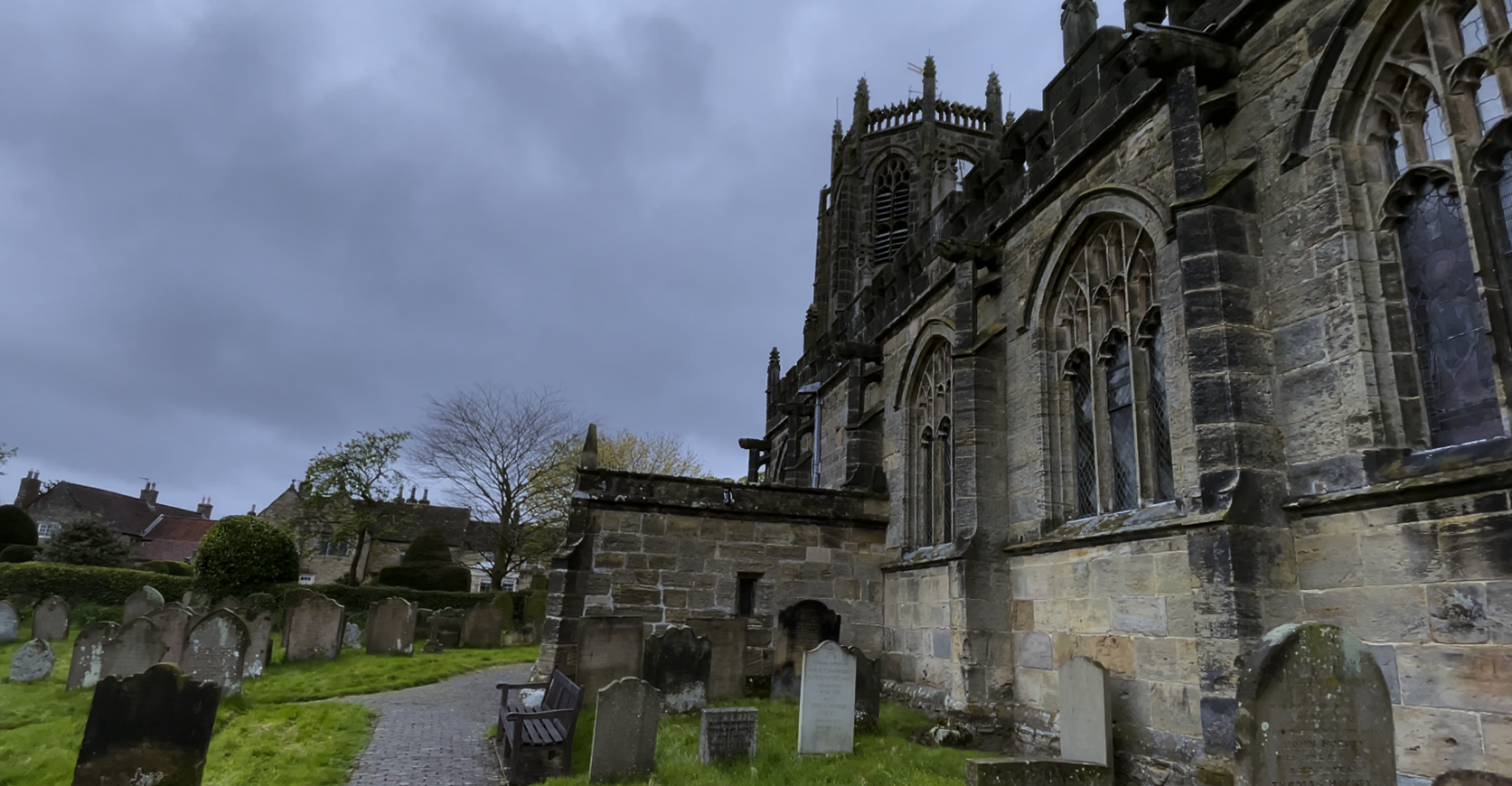 A stone building with a cemetery

Description automatically generated