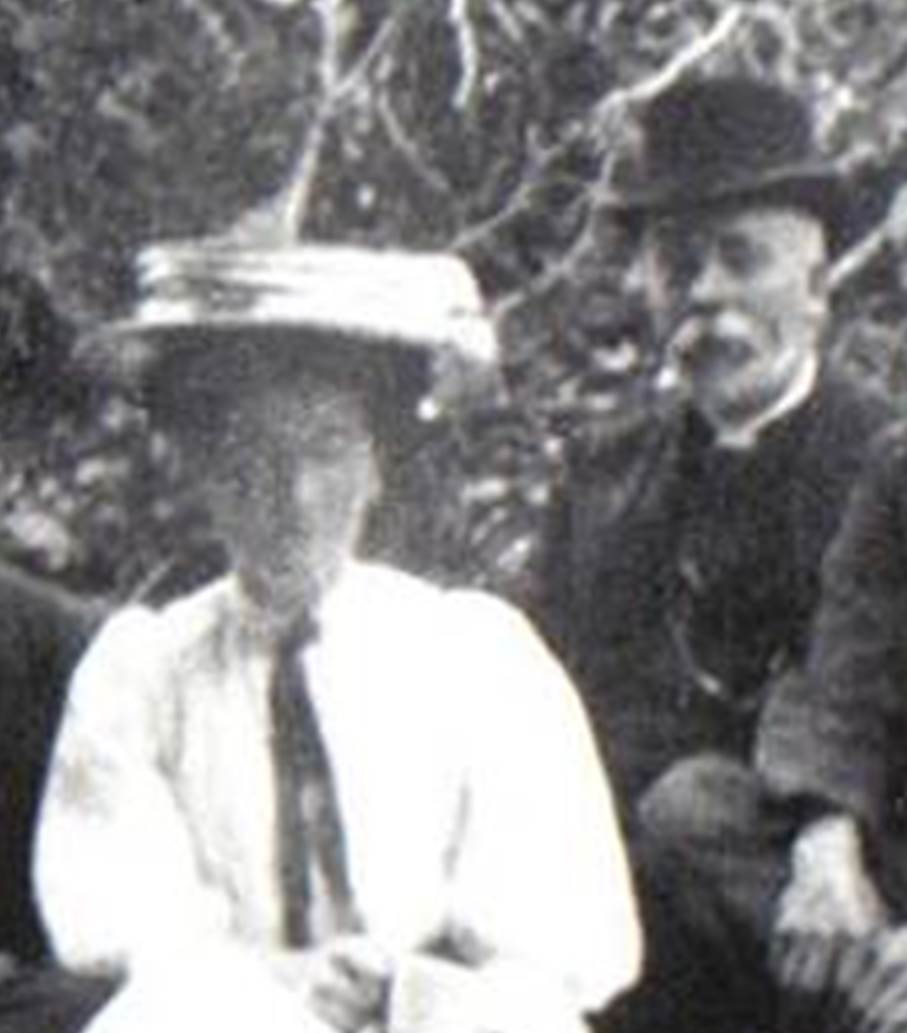 A vintage photo of a group of people posing for the camera

Description automatically generated