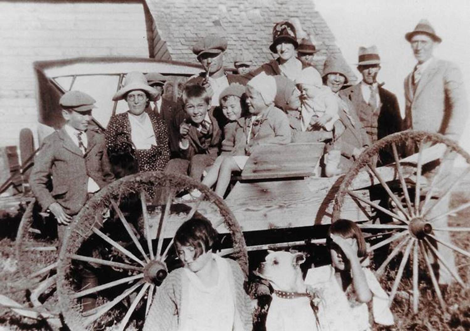 A group of people standing in front of a wagon

Description automatically generated