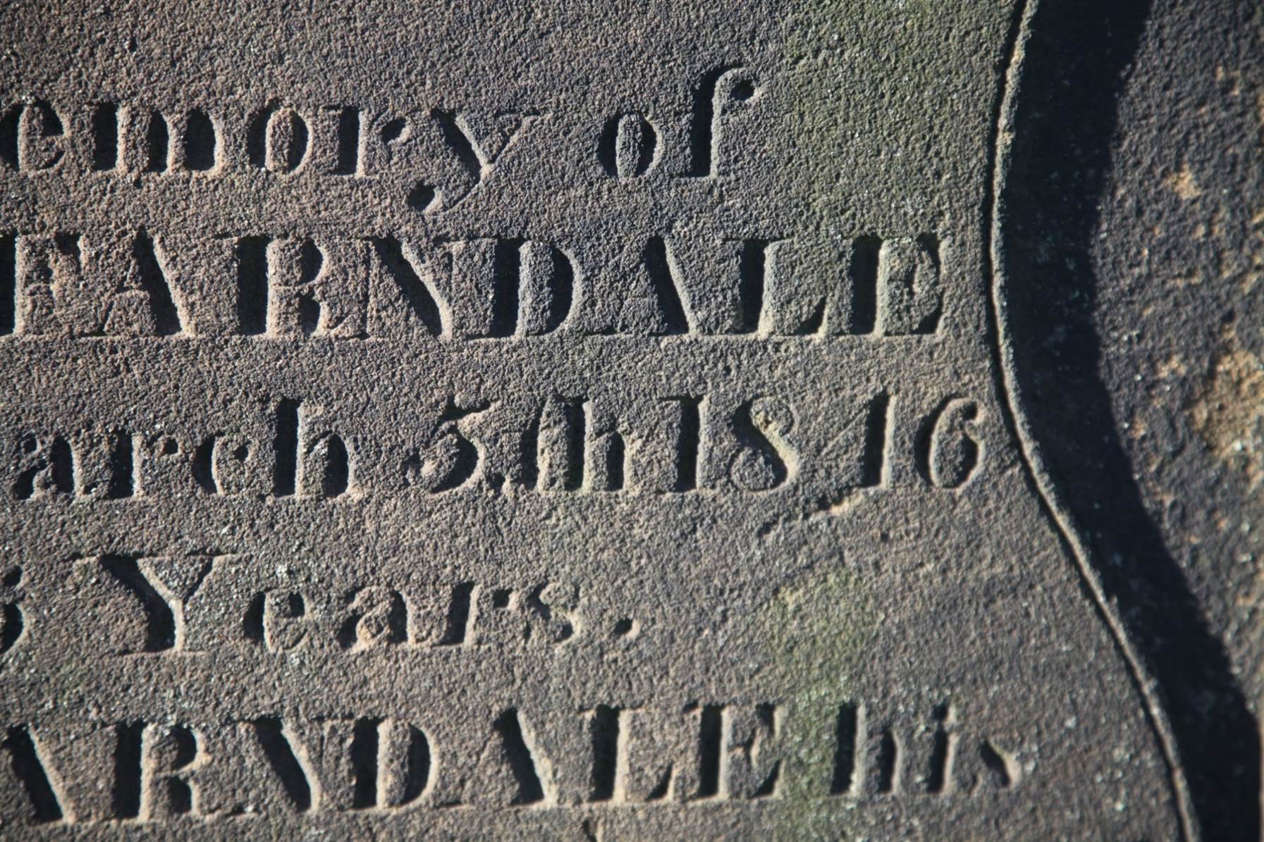 Close-up of a grave stone

Description automatically generated