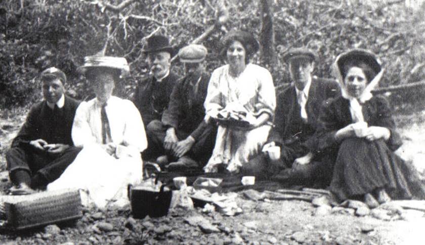 A vintage photo of a group of people posing for the camera

Description automatically generated