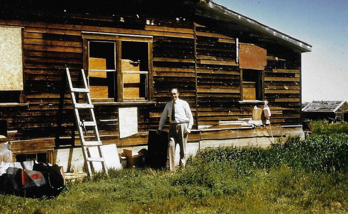 A person standing outside a house

Description automatically generated with low confidence