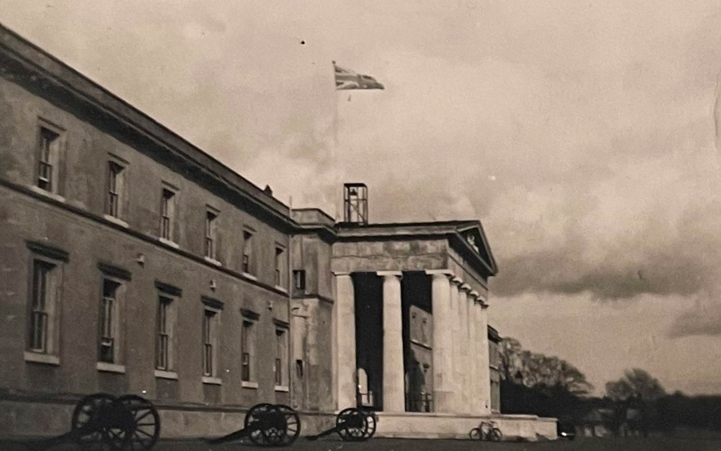 A building with a flag on top

Description automatically generated