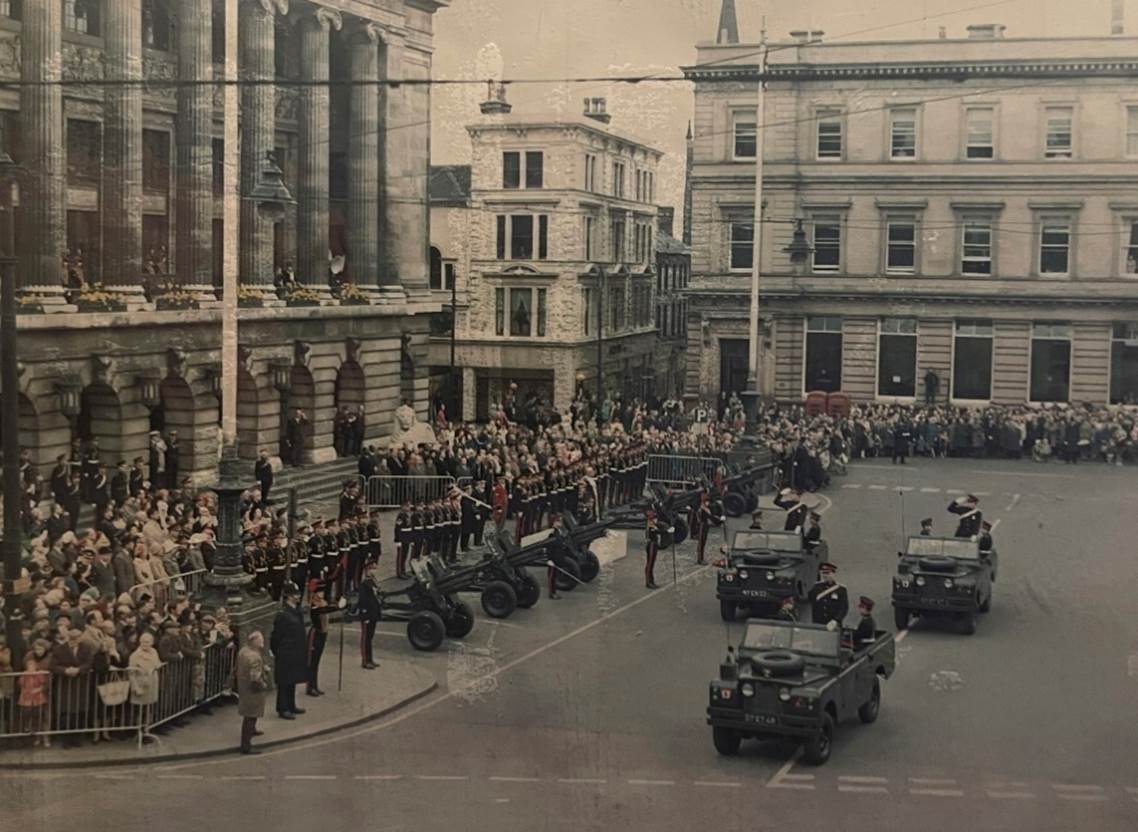 Military vehicles in a street with people in front of them

Description automatically generated