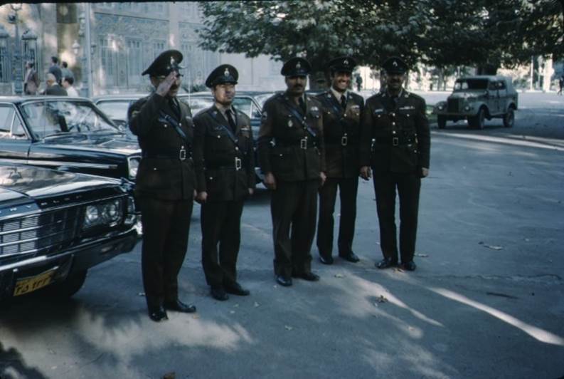 A group of police officers standing in a line

Description automatically generated