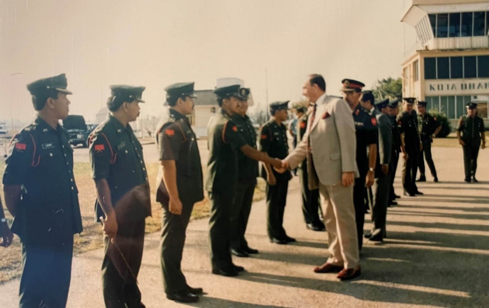 A person shaking hands with a group of people

Description automatically generated