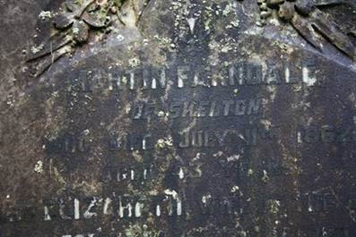 Close-up of a tombstone with engraved text

Description automatically generated