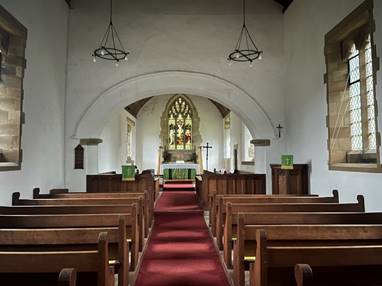 A church with red carpet and pews

Description automatically generated