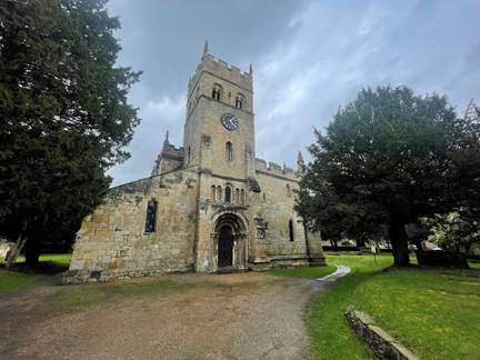 A stone building with a clock tower

Description automatically generated