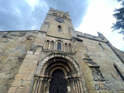 A stone building with a clock tower

Description automatically generated