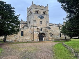 A stone building with a clock tower

Description automatically generated