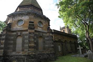 A stone building with a steeple

Description automatically generated