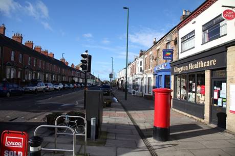 A street with shops and buildings

Description automatically generated