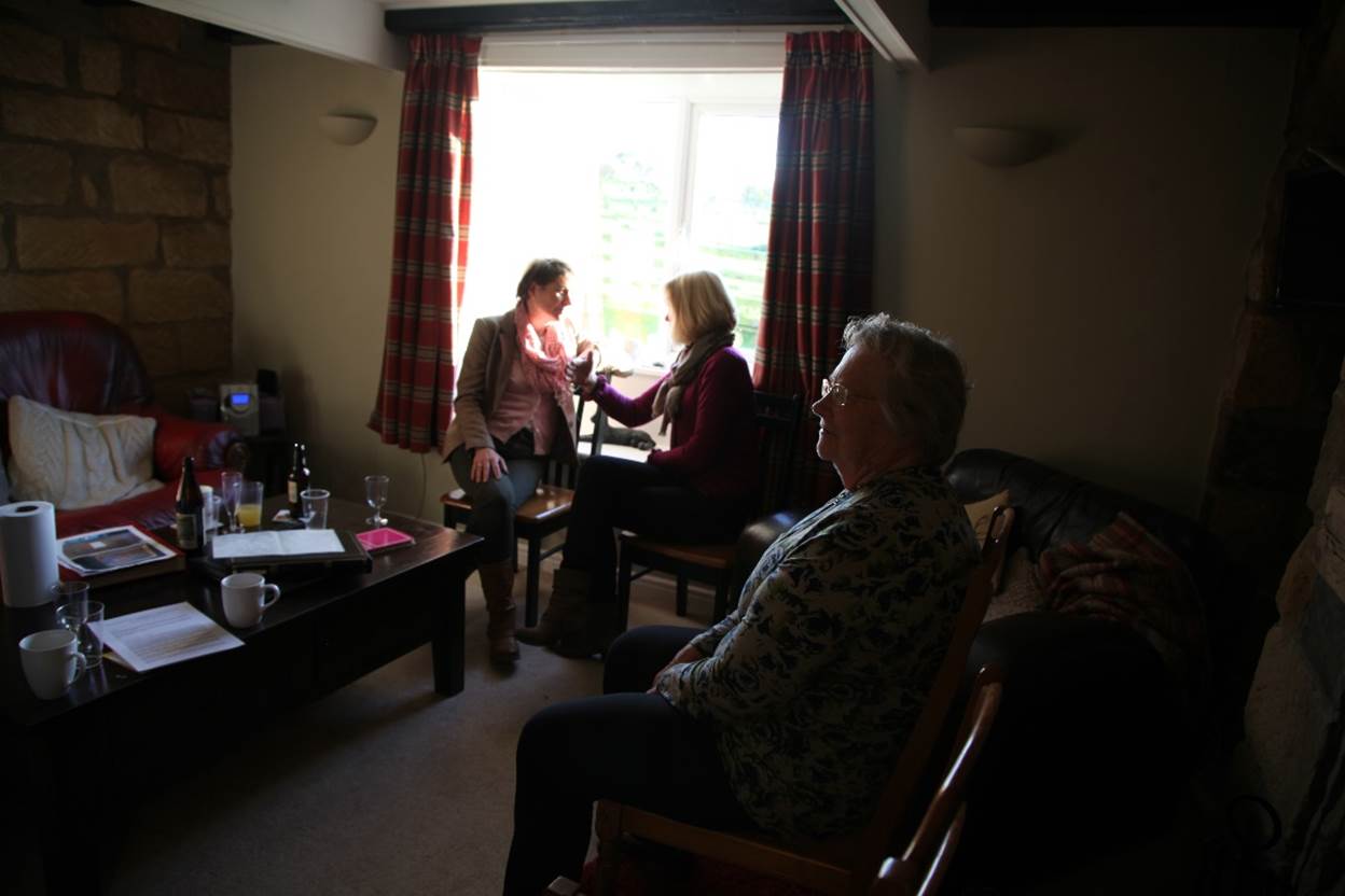 A group of women sitting in a room

Description automatically generated