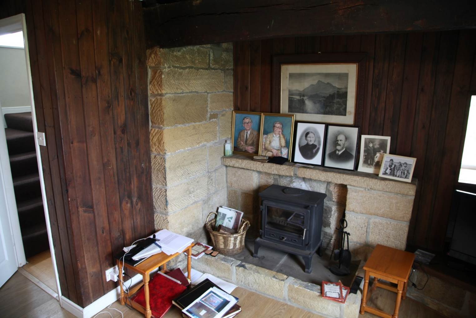 A room with a fireplace and pictures

Description automatically generated