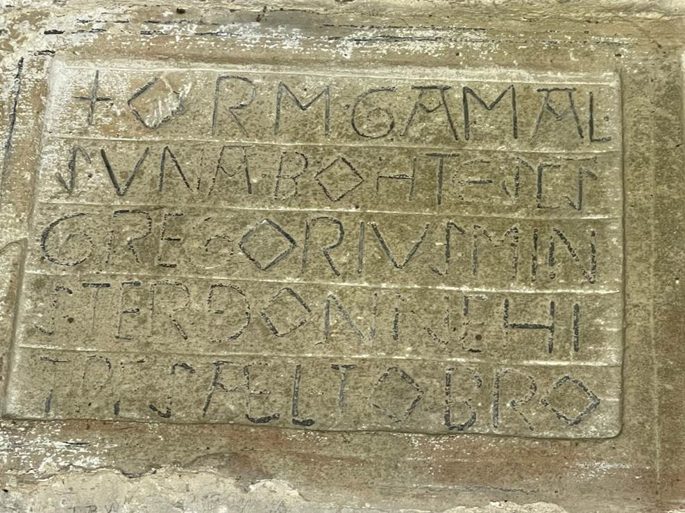 A stone with writing on it

Description automatically generated