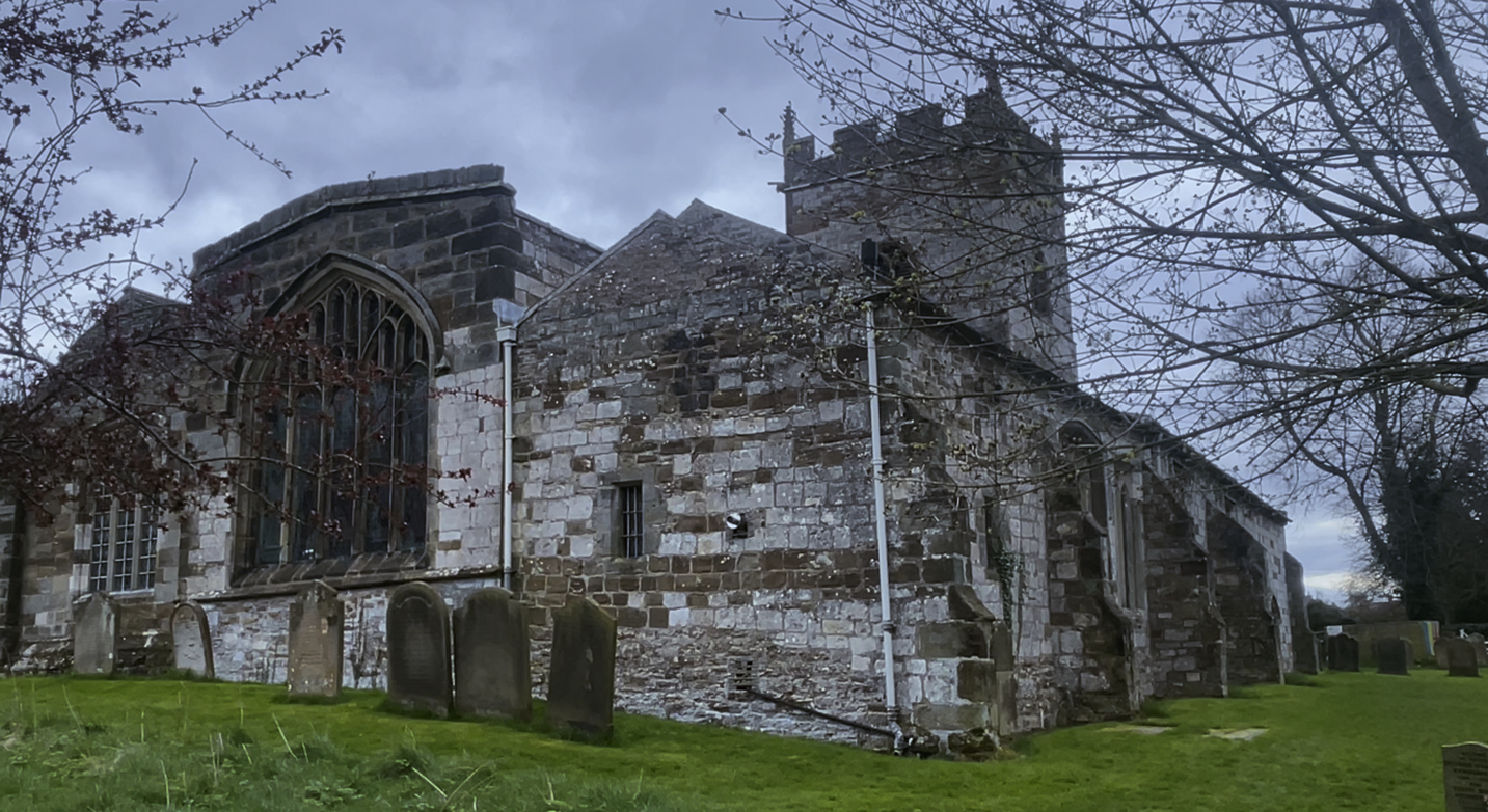 A stone building with a cemetery

Description automatically generated