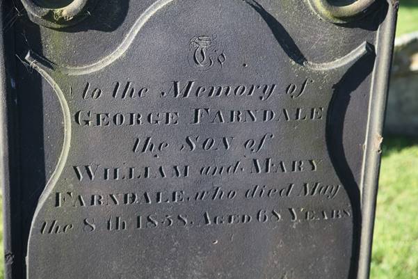 Close-up of a grave stone

Description automatically generated