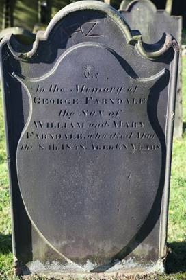 A close-up of a grave stone

Description automatically generated