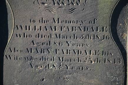 Close-up of a grave stone

Description automatically generated