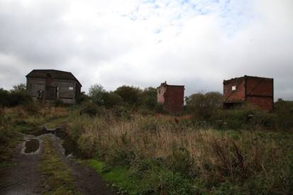 A dirt path leading to a ruined building

Description automatically generated with medium confidence