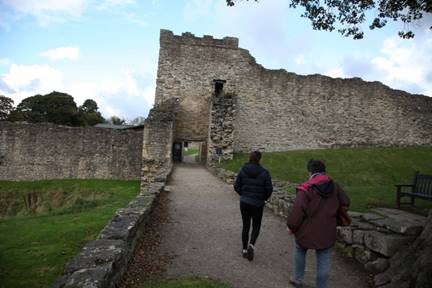 A couple of people walking down a path

Description automatically generated