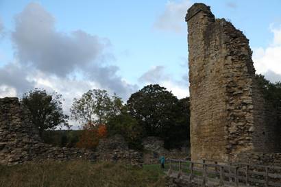 A stone tower in a field

Description automatically generated