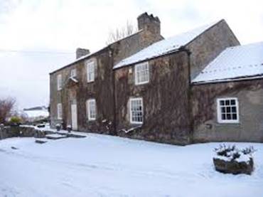 A house with snow on the ground

Description automatically generated