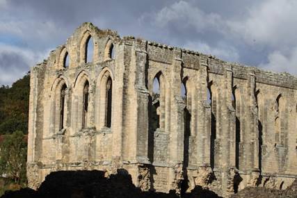 A stone building with many windows

Description automatically generated