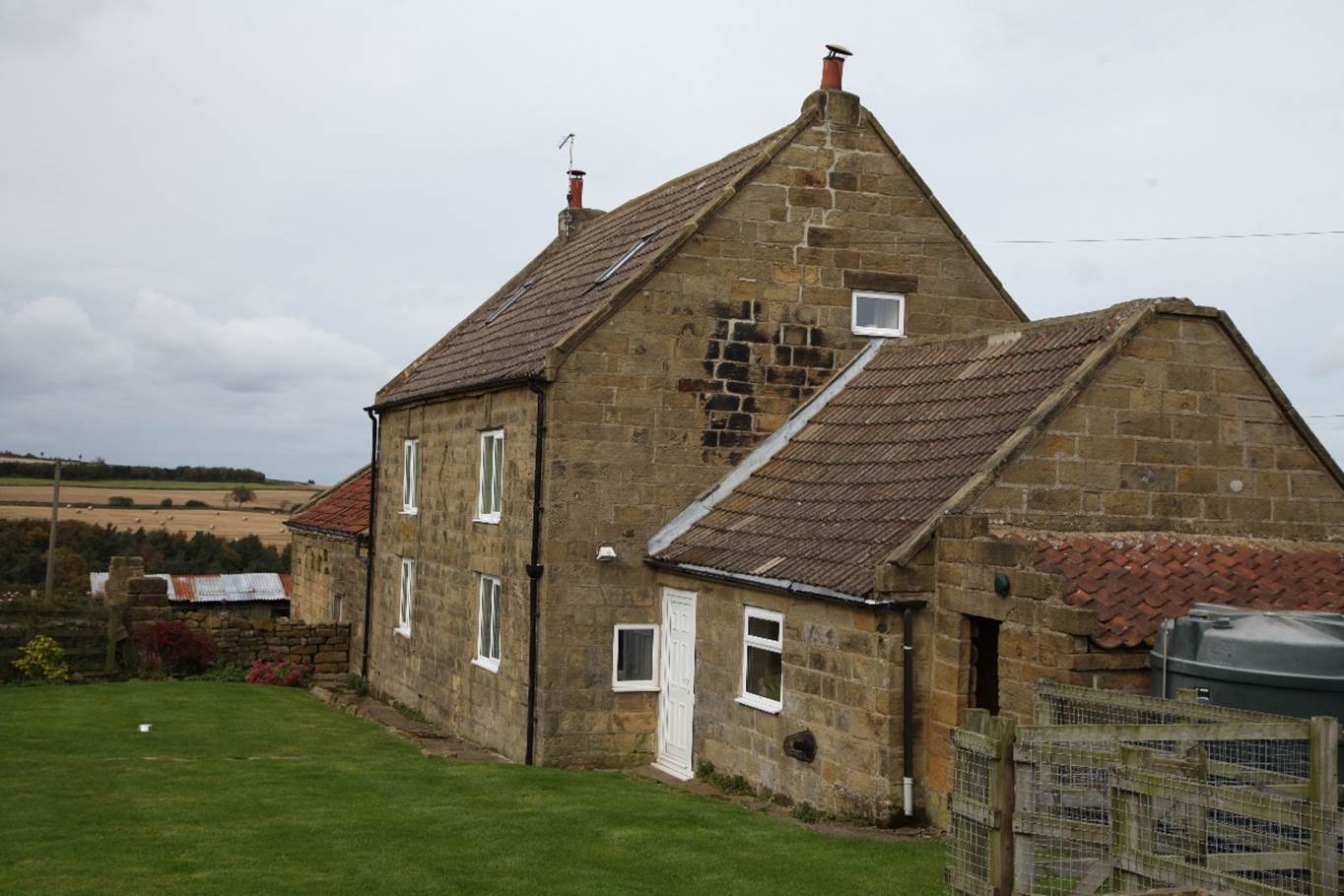 A stone house with a lawn

Description automatically generated